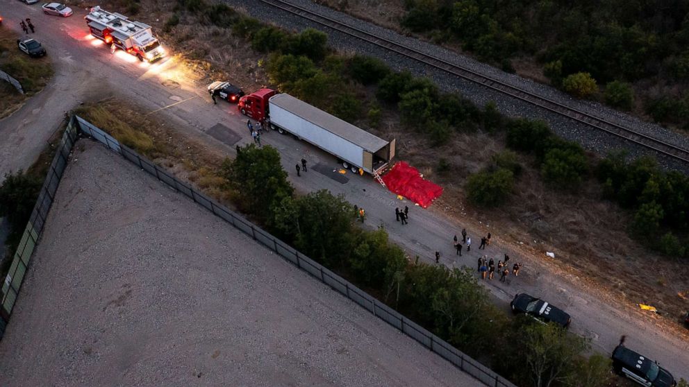 PHOTO: Members of law enforcement investigate a tractor trailer, June 27, 2022, in San Antonio, Texas, where at least 46 people, were found dead.