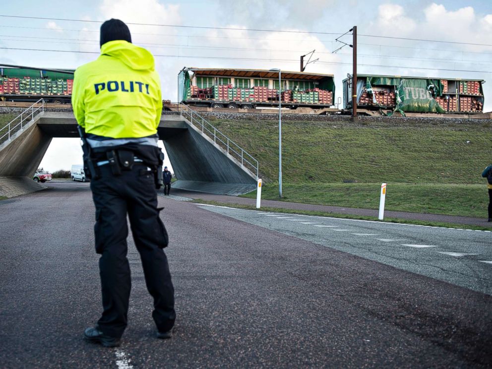PHOTO: A police officer looks on near a damaged cargo train compartment near the Storebaelt bridge, near Nyborg in Denmark, Jan. 2, 2019.