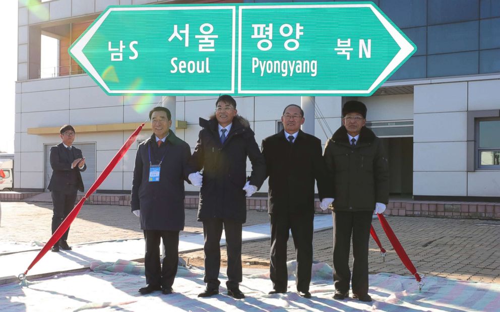PHOTO: Officials from South and North Korea stand in front of a road sign during the ceremony for a project to modernize and connect roads and railways over the border between the Koreas at Panmun Station, Dec. 26, 2018, in Kaesong, North Korea.