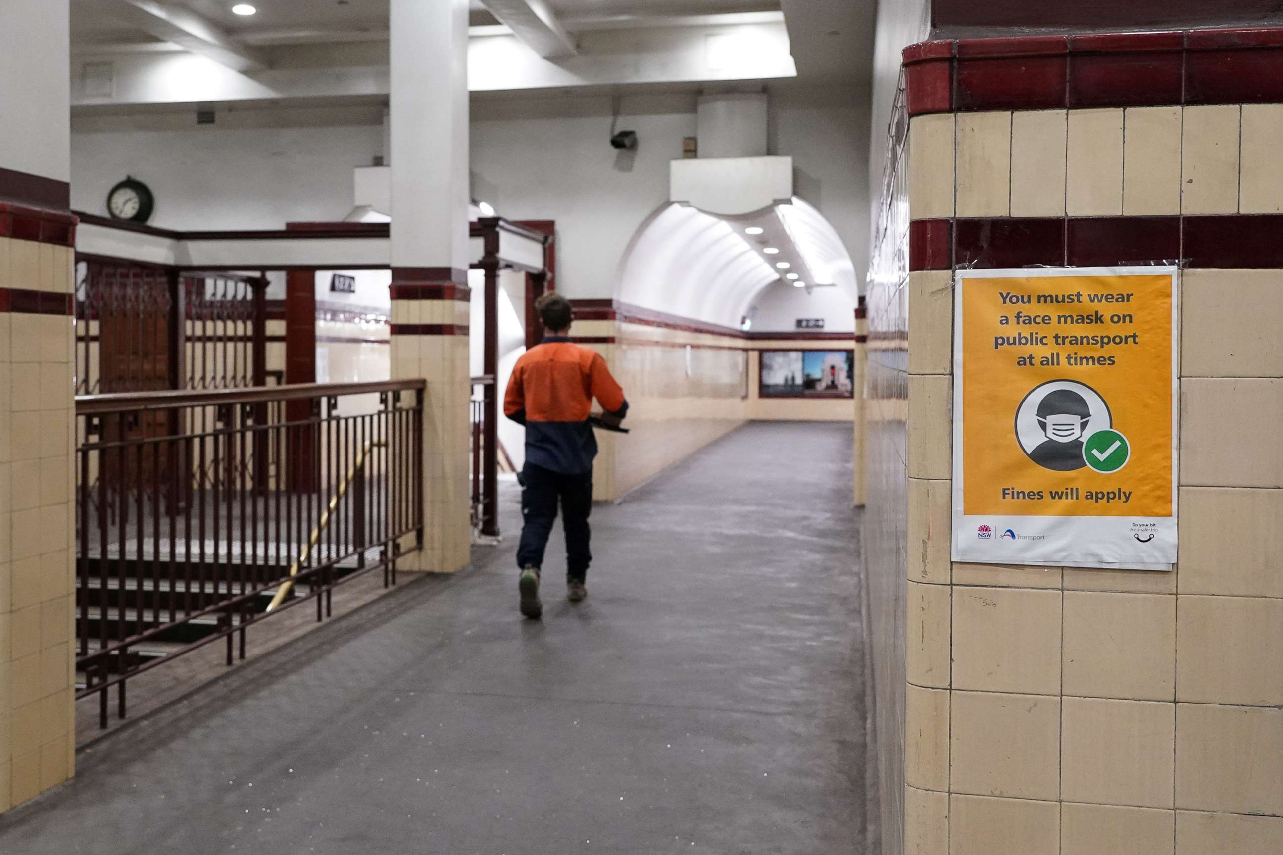 PHOTO:A public health message mandating that passengers wear face masks on public transport is posted on the wall of a mostly empty city centre train station during a lockdown to curb the spread of a COVID-19 outbreak in Sydney, Australia, Sept. 9, 2021.