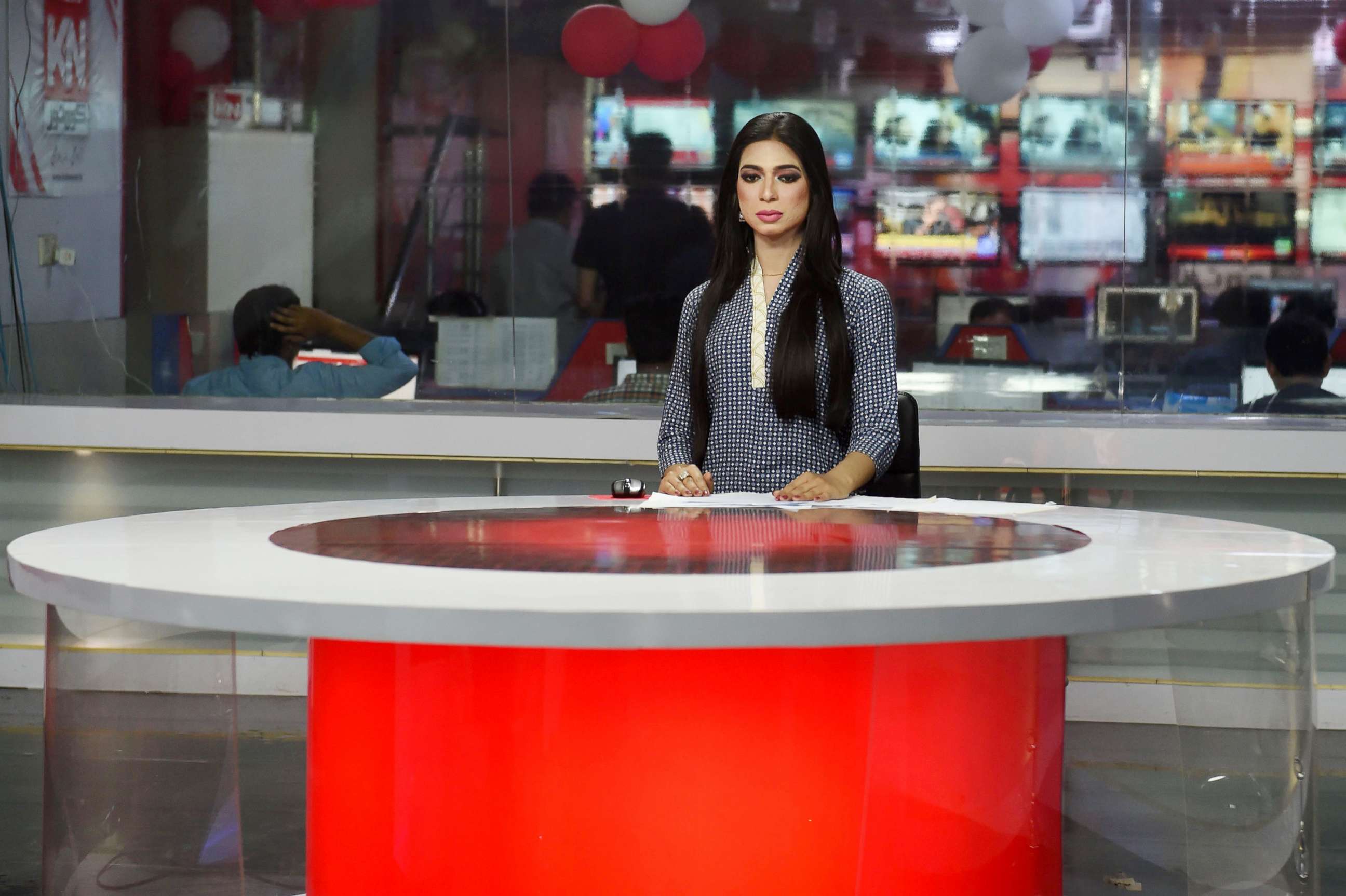PHOTO: Pakistan's first transgender news anchor Marvia Malik, reads the news on air for the private channel Kohenoor in Lahore, March 27, 2018.