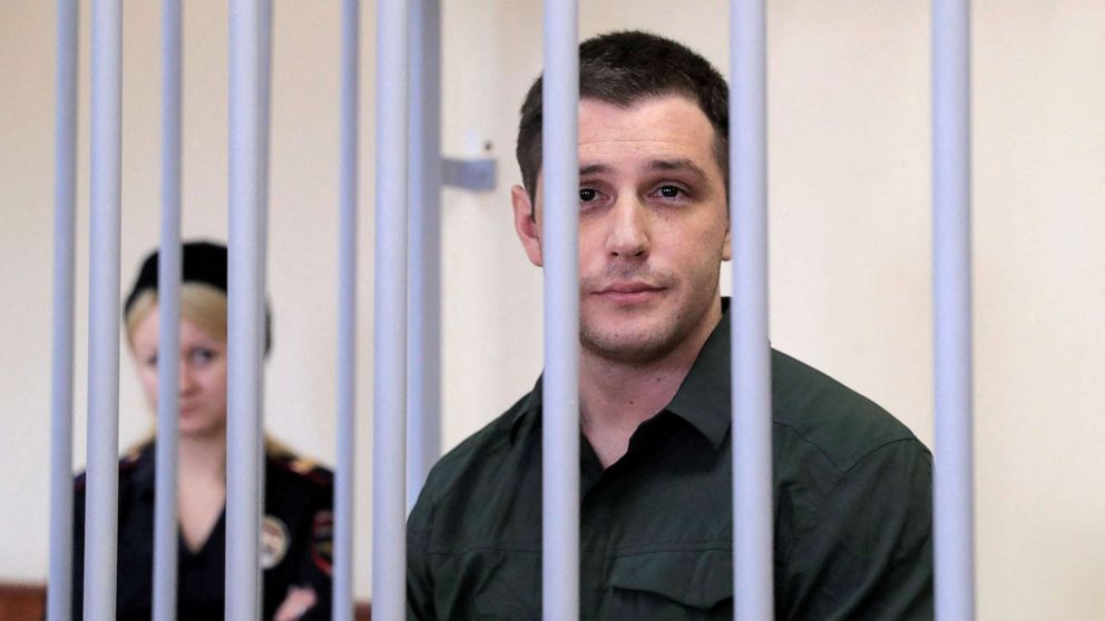 PHOTO: Former U.S. Marine Trevor Reed, who was detained in 2019 and accused of assaulting police officers, stands inside a defendants' cage during a court hearing in Moscow, March 11, 2020.