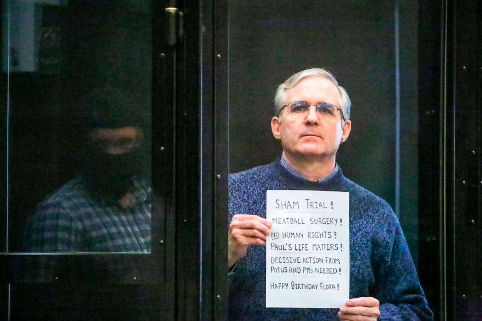 PHOTO: Paul Whelan, a former U.S. marine who was arrested for alleged spying, holds a protest sign as he listens to the verdict in a courtroom at the Moscow City Court in Moscow, June 15, 2020. 