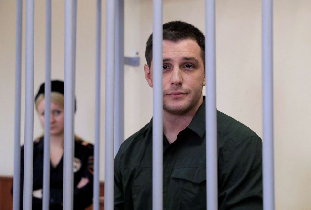 FILE PHOTO: U.S. citizen and former Marine Trevor Reed stands inside a defendants' cage during a court hearing in Moscow, Russia, March 11, 2020.