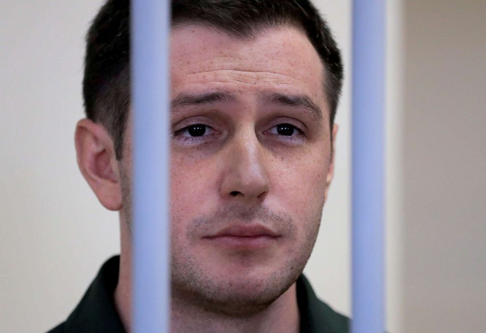 PHOTO: In this March 11, 2020, file photo, former U.S. Marine Trevor Reed stands inside a defendants' cage during a court hearing in Moscow.