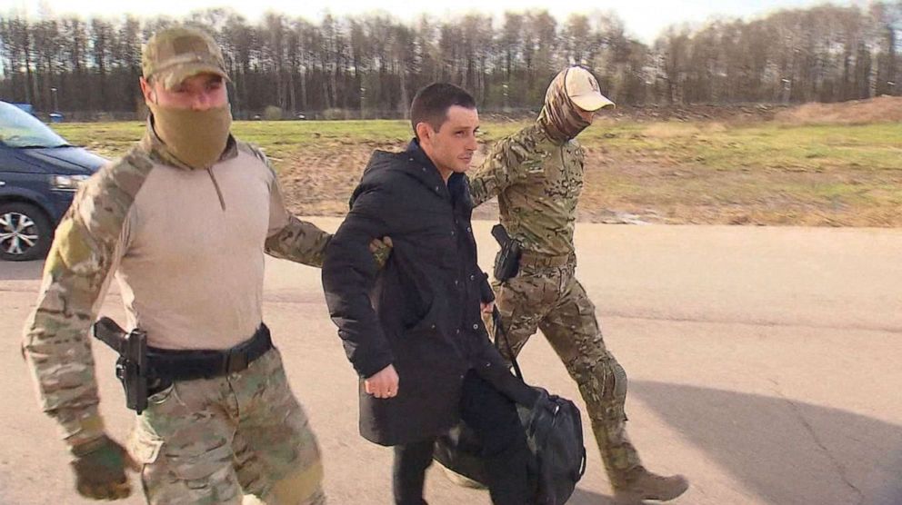 PHOTO: Former U.S. Marine Trevor Reed, who was detained in 2019 and accused of assaulting police officers, is escorted to a plane by Russian service members as part of a prisoner swap between the U.S. and Russia, in Moscow, April 27, 2022. 