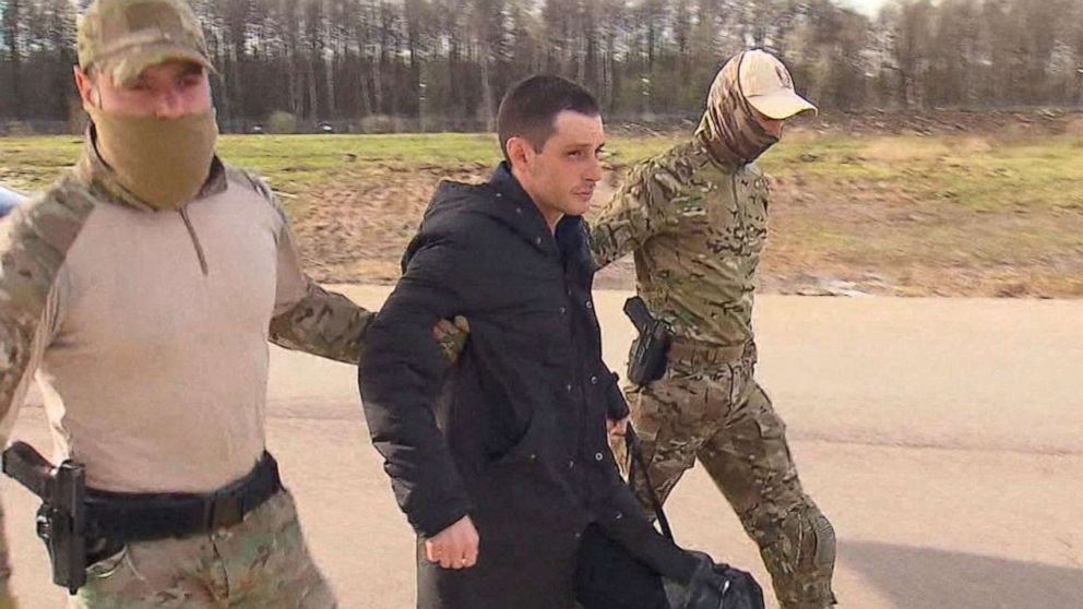 PHOTO: Former U.S. Marine Trevor Reed, who was detained in 2019 and accused of assaulting police officers, is escorted to a plane by Russian service members as part of a prisoner swap between the U.S. and Russia, in Moscow, April 27, 2022. 