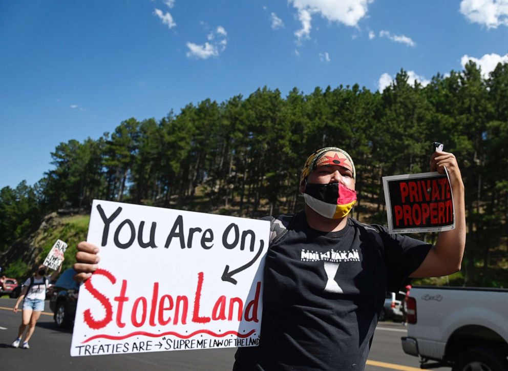 PHOTO: Activists and members of different Native American tribes from the region protest in Keystone, South Dakota on July 3, 2020, near Mount Rushmore ahead of the July 4th celebration with President Donald Trump.