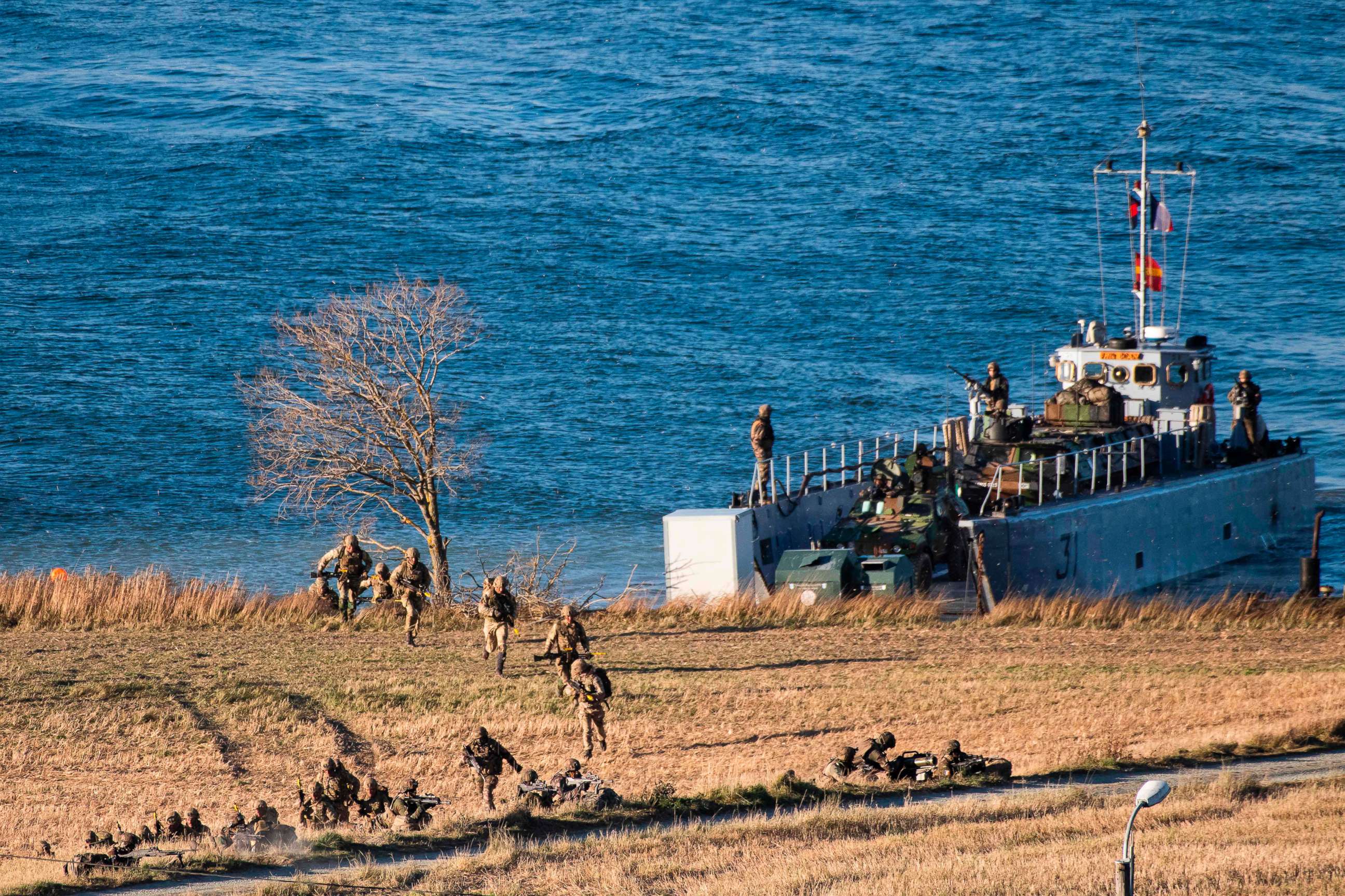 PHOTO: Marines from France and the United Kingdom jump off a French Landing Craft during a Joint demonstration as part of the NATO Trident Juncture 2018 exercise, in Byneset near Trondheim, Norway, Oct. 30, 2018.