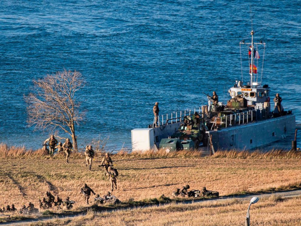 PHOTO: Marines from France and the United Kingdom jump off a French Landing Craft during a Joint demonstration as part of the NATO Trident Juncture 2018 exercise, in Byneset near Trondheim, Norway, Oct. 30, 2018.