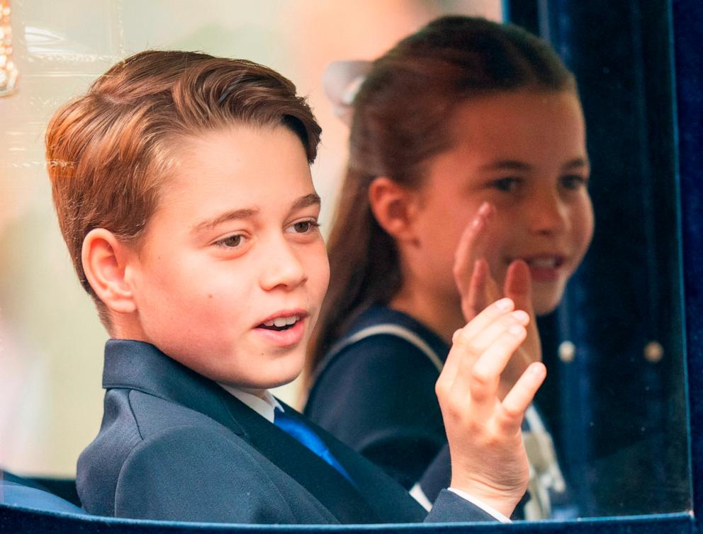 PHOTO: Prince George of Wales and Princess Charlotte of Wales wave during Trooping the Colour, June 15, 2024, in London.