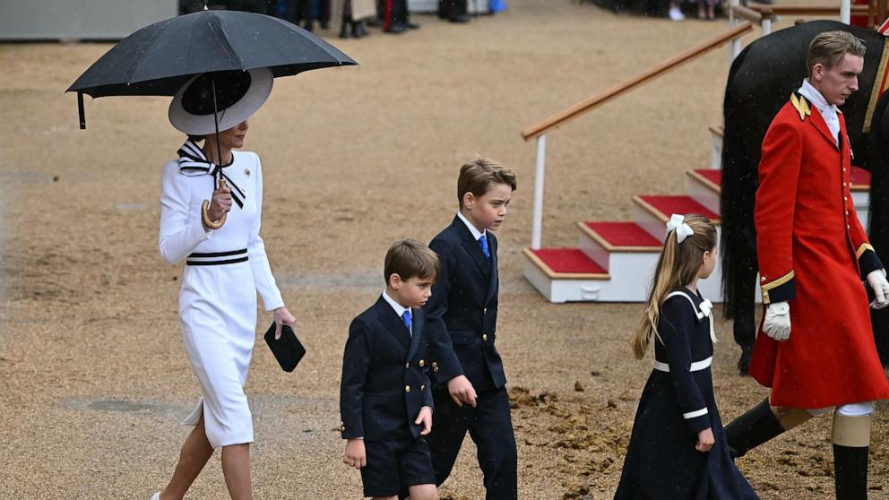 PHOTO: Britain's Catherine, Princess of Wales, shelters from the rain as she walks with her children Prince George of Wales, Princess Charlotte of Wales and Prince Louis of Wales during the 'Trooping the Colour' in London, June 15, 2024.

