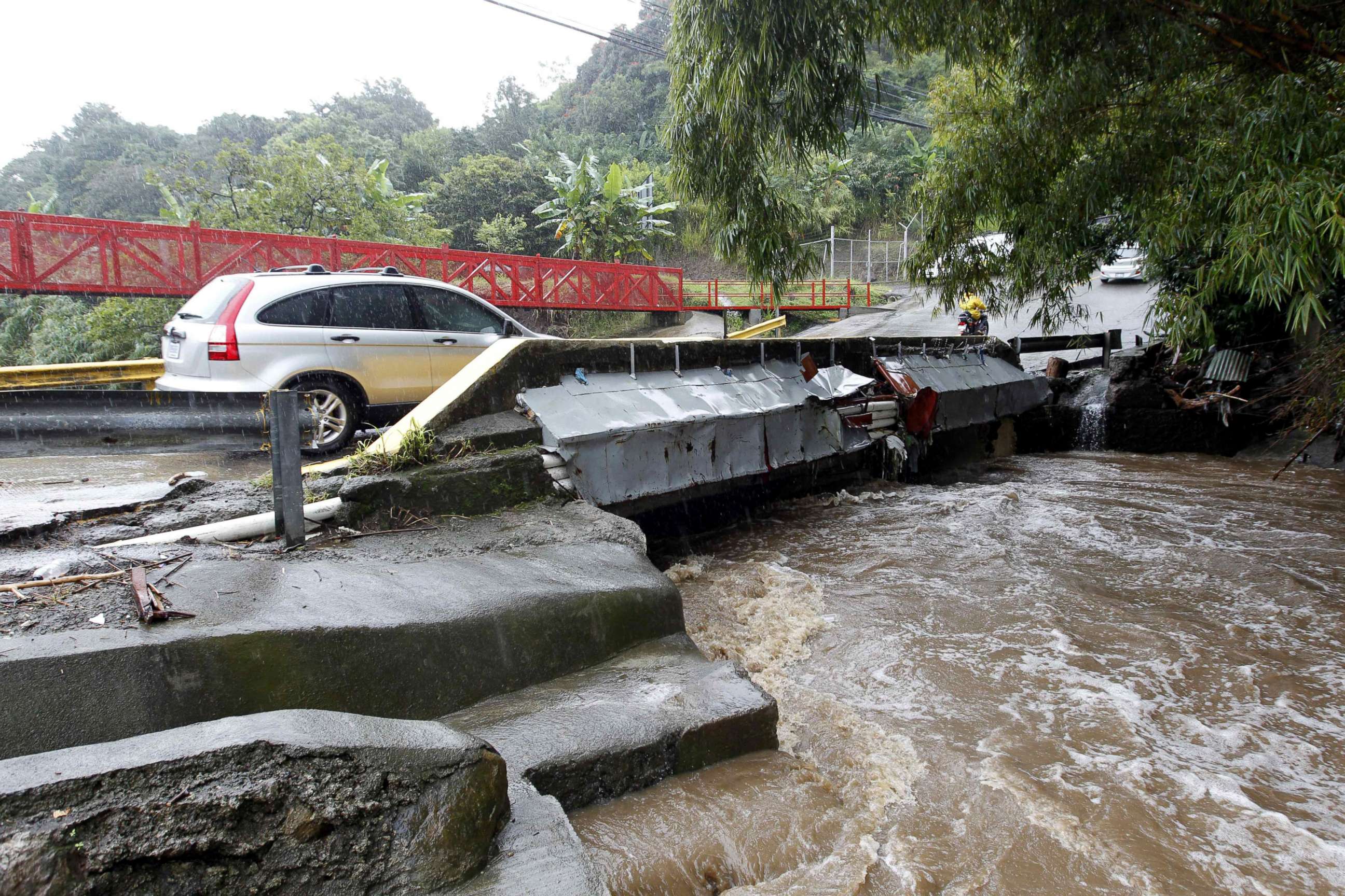 PHOTO: A vehicle crossing a bridge over a high river due to hard rains in Sabanilla area in Alajuelita, Costa Rica, Oct. 5, 2017.