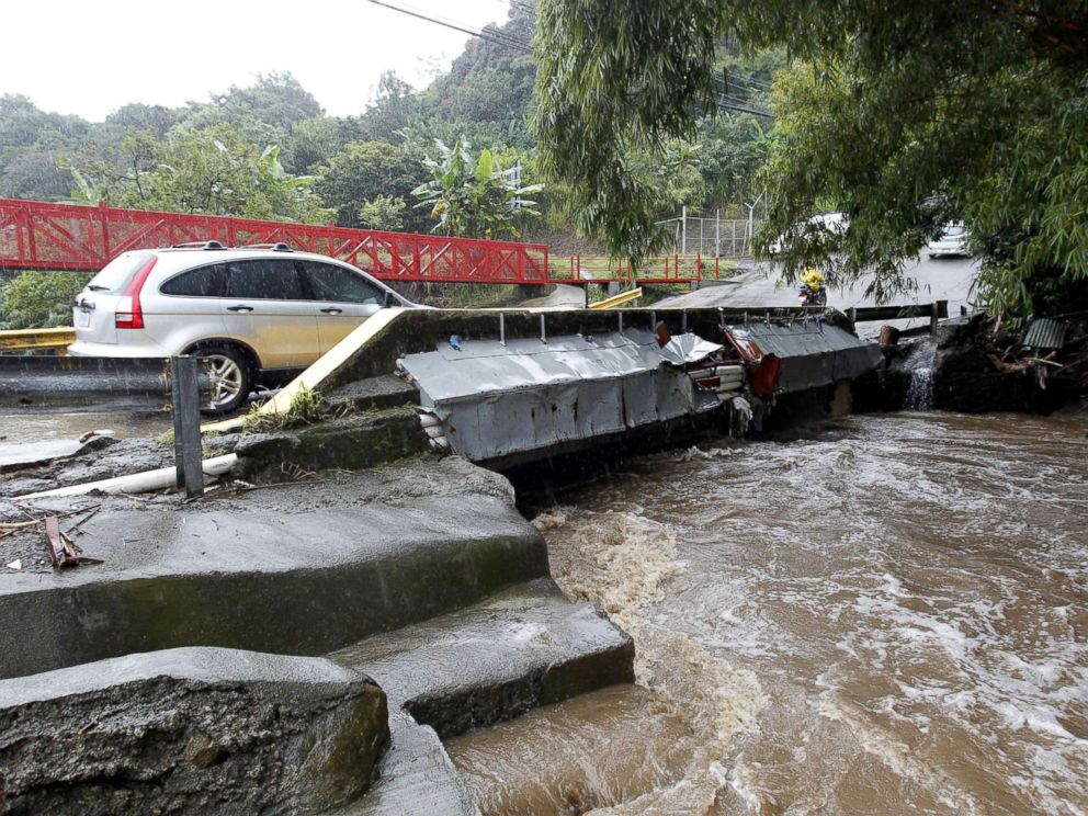 PHOTO: A vehicle crossing a bridge over a high river due to hard rains in Sabanilla area in Alajuelita, Costa Rica, Oct. 5, 2017.