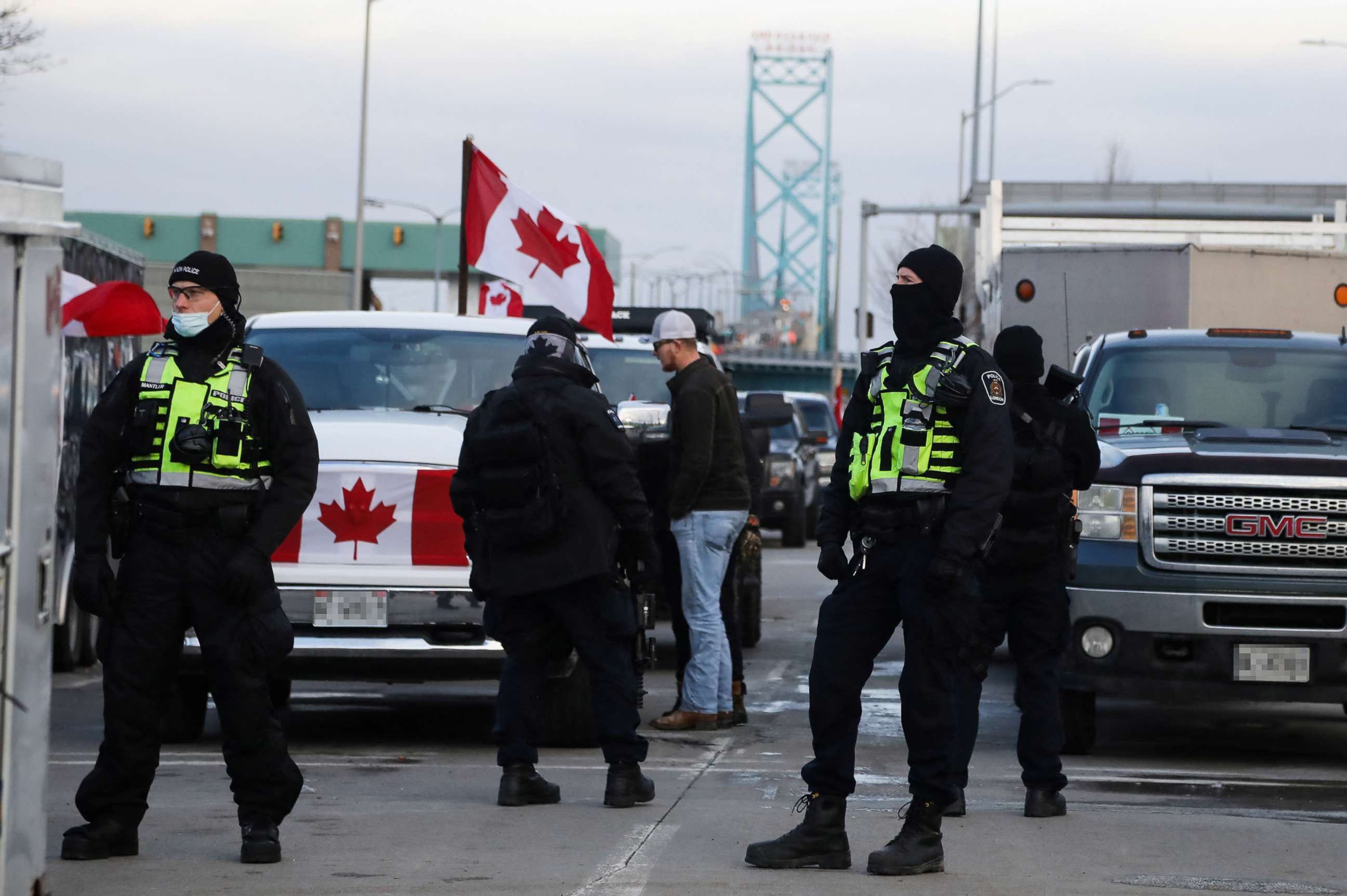 PHOTO: Police officers stand guard on a street as truckers and supporters continue blocking access to the Ambassador Bridge, which connects Detroit and Windsor, in protest against COVID-19 vaccine mandates, in Windsor, Ontario, Canada, Feb. 12, 2022. 