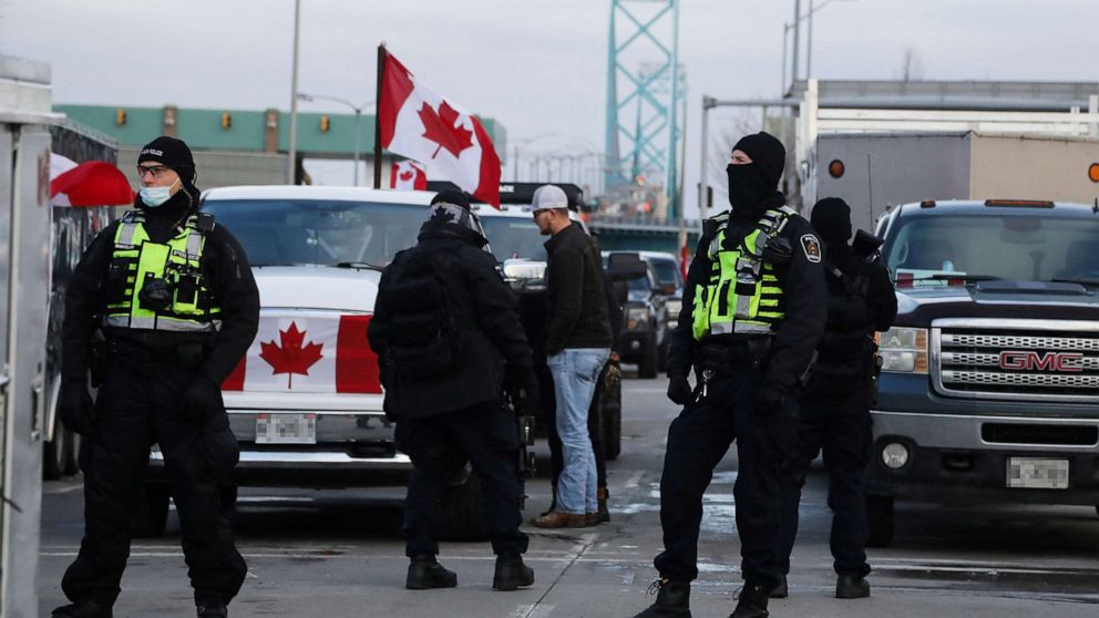 PHOTO: Police officers stand guard on a street as truckers and supporters continue blocking access to the Ambassador Bridge, which connects Detroit and Windsor, in protest against COVID-19 vaccine mandates, in Windsor, Ontario, Canada, Feb. 12, 2022. 