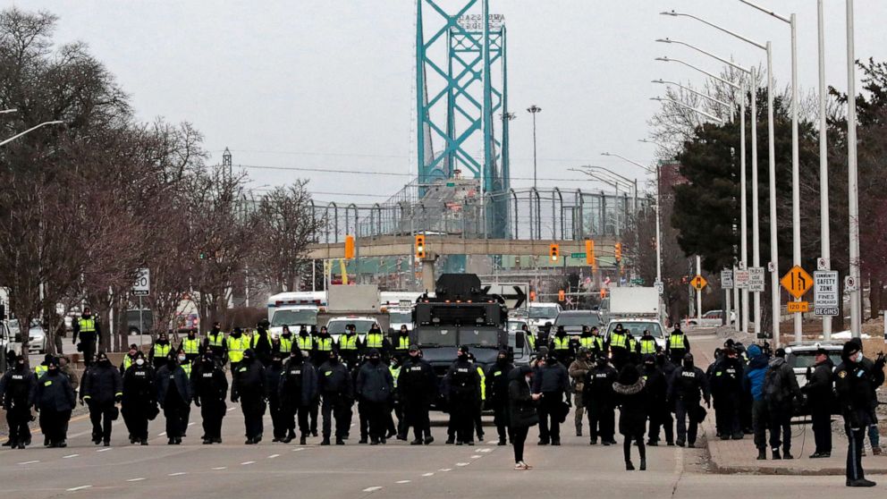 PHOTO: Police gather to clear protestors against Covid-19 vaccine mandates who blocked the entrance to the Ambassador Bridge in Windsor, Ontario, Canada, on Feb. 13, 2022.