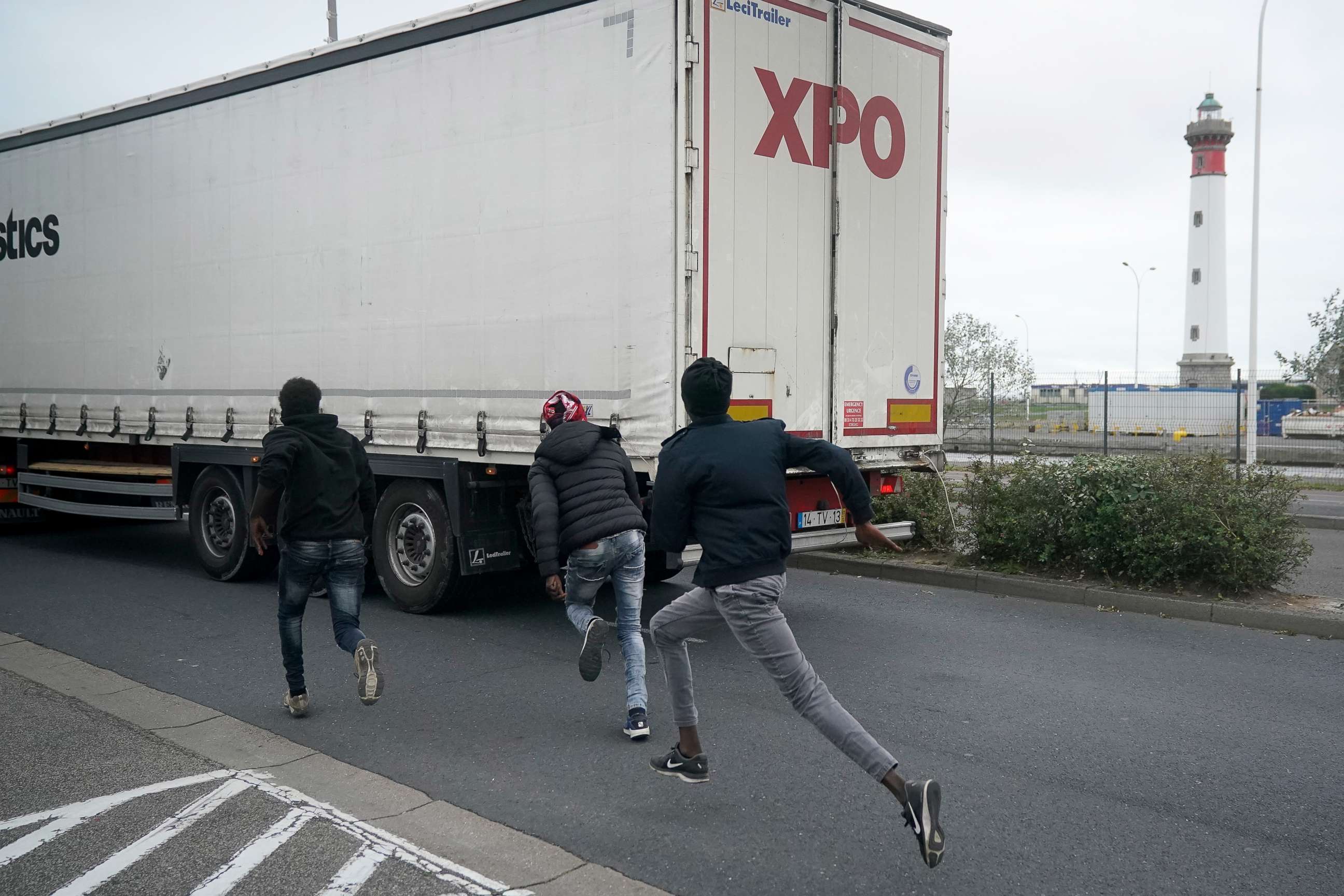 PHOTO: Migrants try to board a truck at Ouistreham ferry port in the hope of reaching the U.K. on Sept. 12, 2018, in Ouistreham, France.
