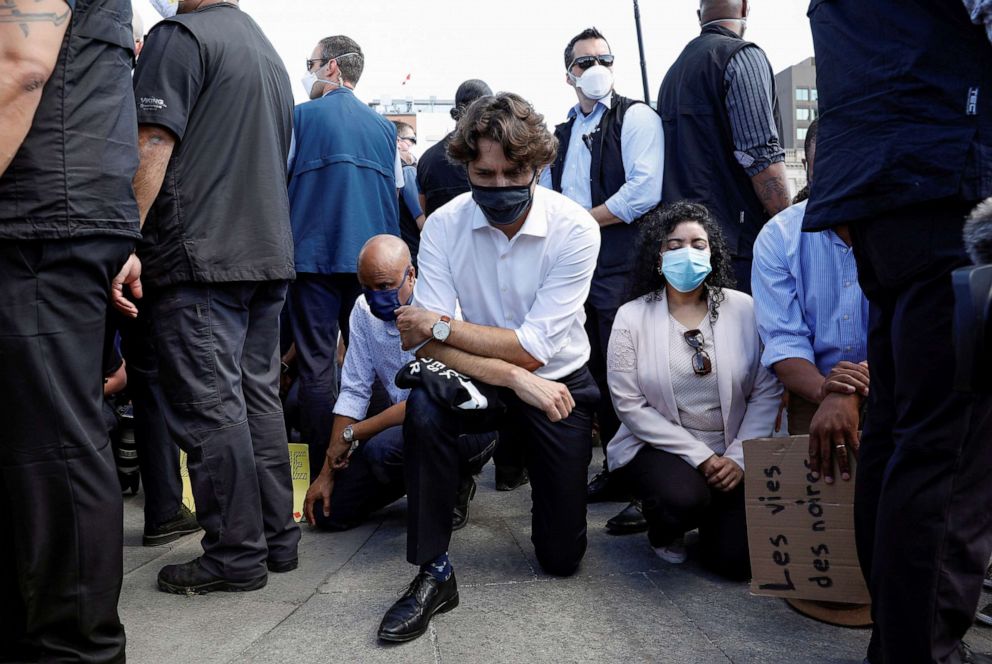 PHOTO: Canada's Prime Minister Justin Trudeau wears a mask as he takes a knee during a rally against the death in Minneapolis police custody of George Floyd, on Parliament Hill, in Ottawa, Ontario, Canada, June 5, 2020.