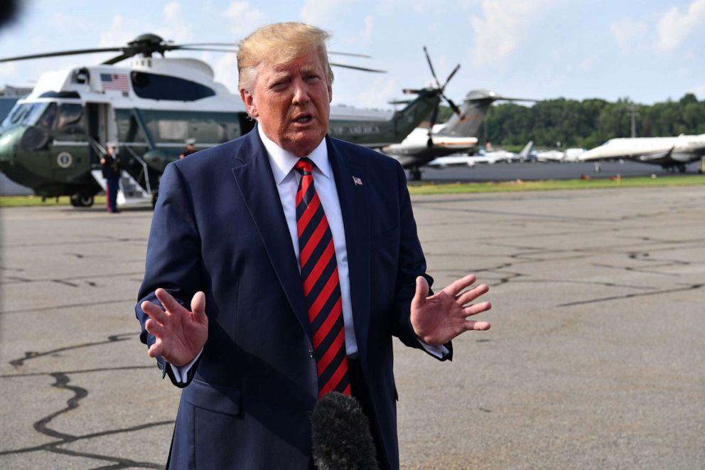 PHOTO: US President Donald Trump speaks to the press before boarding Air Force One in Morristown, New Jersey, on August 18, 2019. 