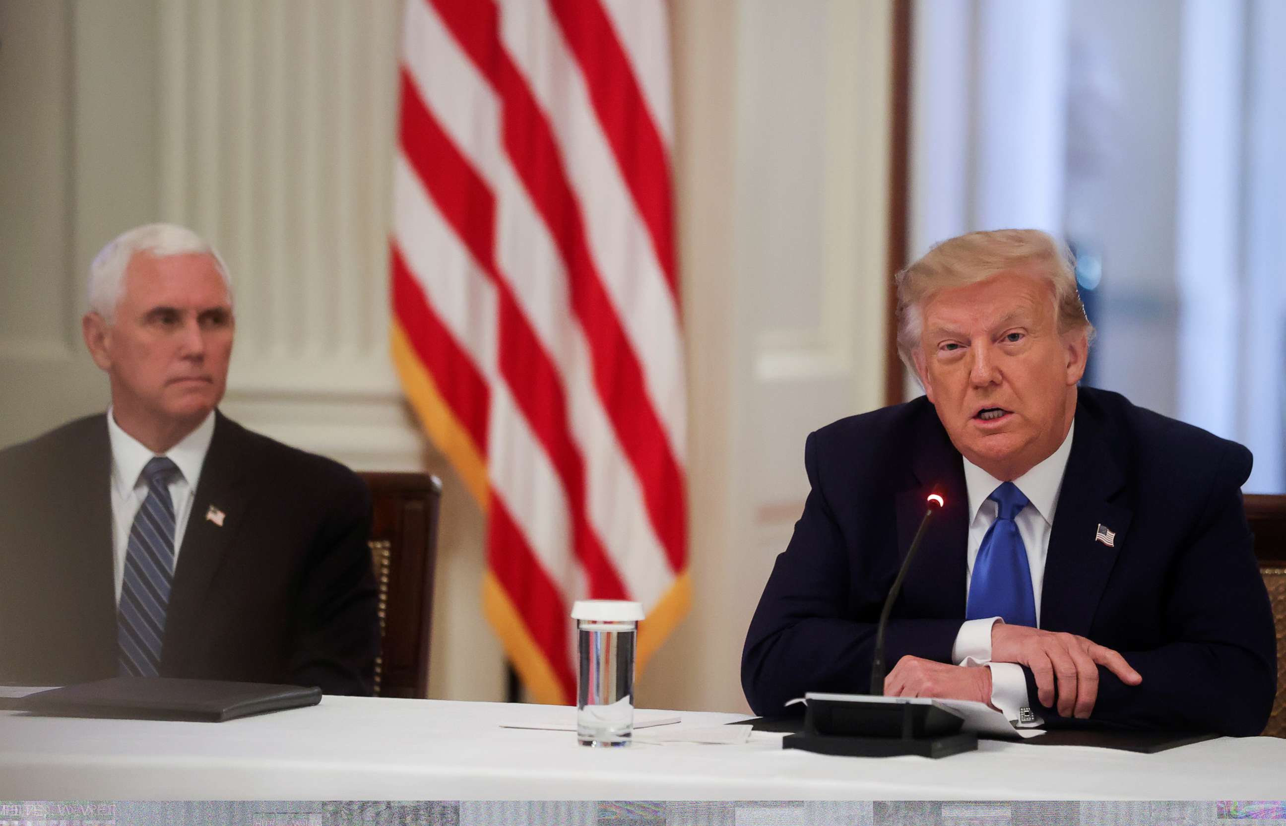 PHOTO: President Donald Trump speaks next to Vice President Mike Pence during a roundtable discussion on law enforcement in the East Room of the White House in Washington, U.S., July 13, 2020.