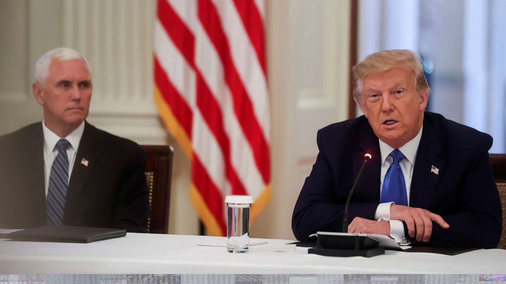 PHOTO: President Donald Trump speaks next to Vice President Mike Pence during a roundtable discussion on law enforcement in the East Room of the White House in Washington, U.S., July 13, 2020.