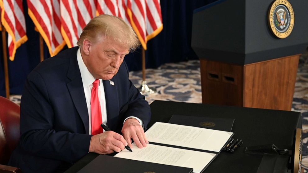 PHOTO: President Donald Trump signs executive orders extending coronavirus economic relief, during a news conference in Bedminster, N.J. on Aug. 8, 2020.