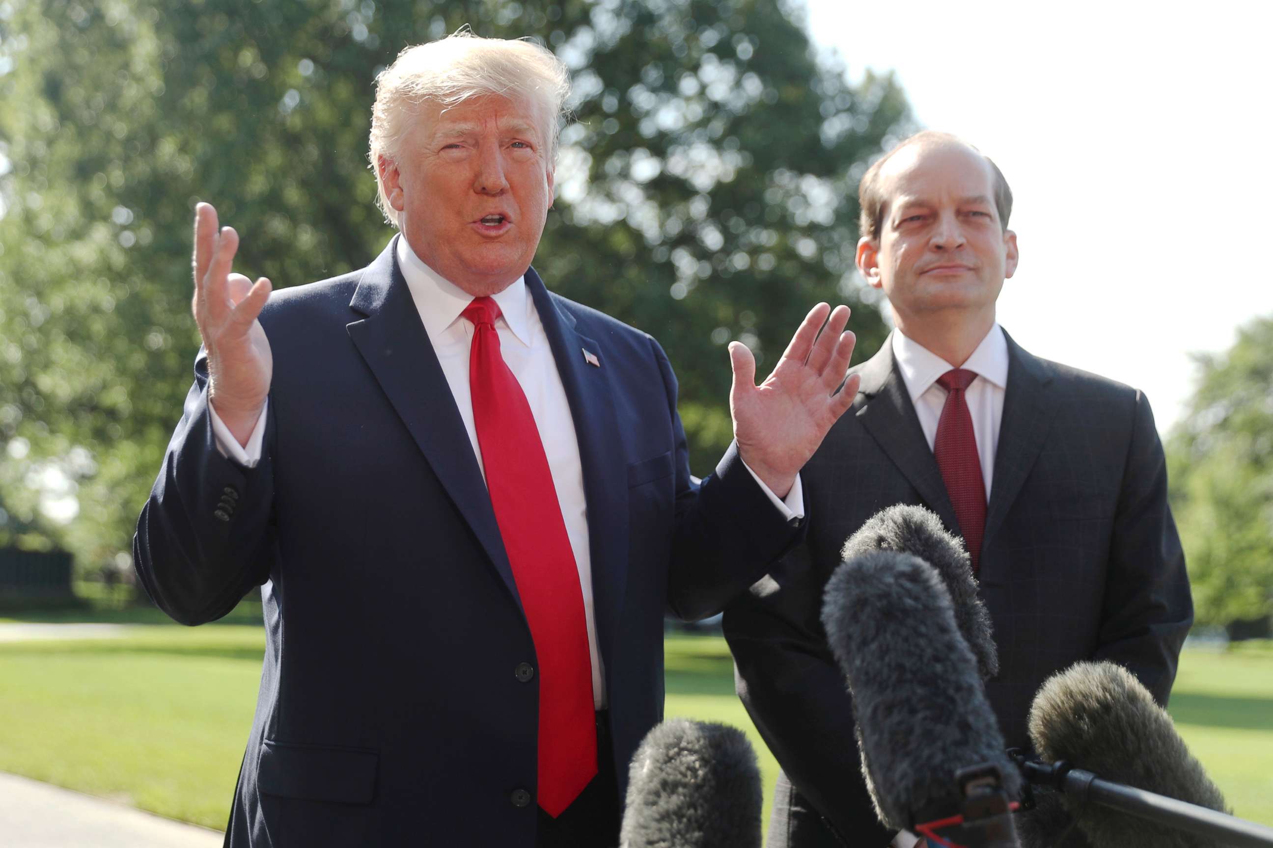 PHOTO: President Donald Trump speaks to members of the media with Secretary of Labor Alex Acosta on the South Lawn of the White House in Washington, July 12, 2019.