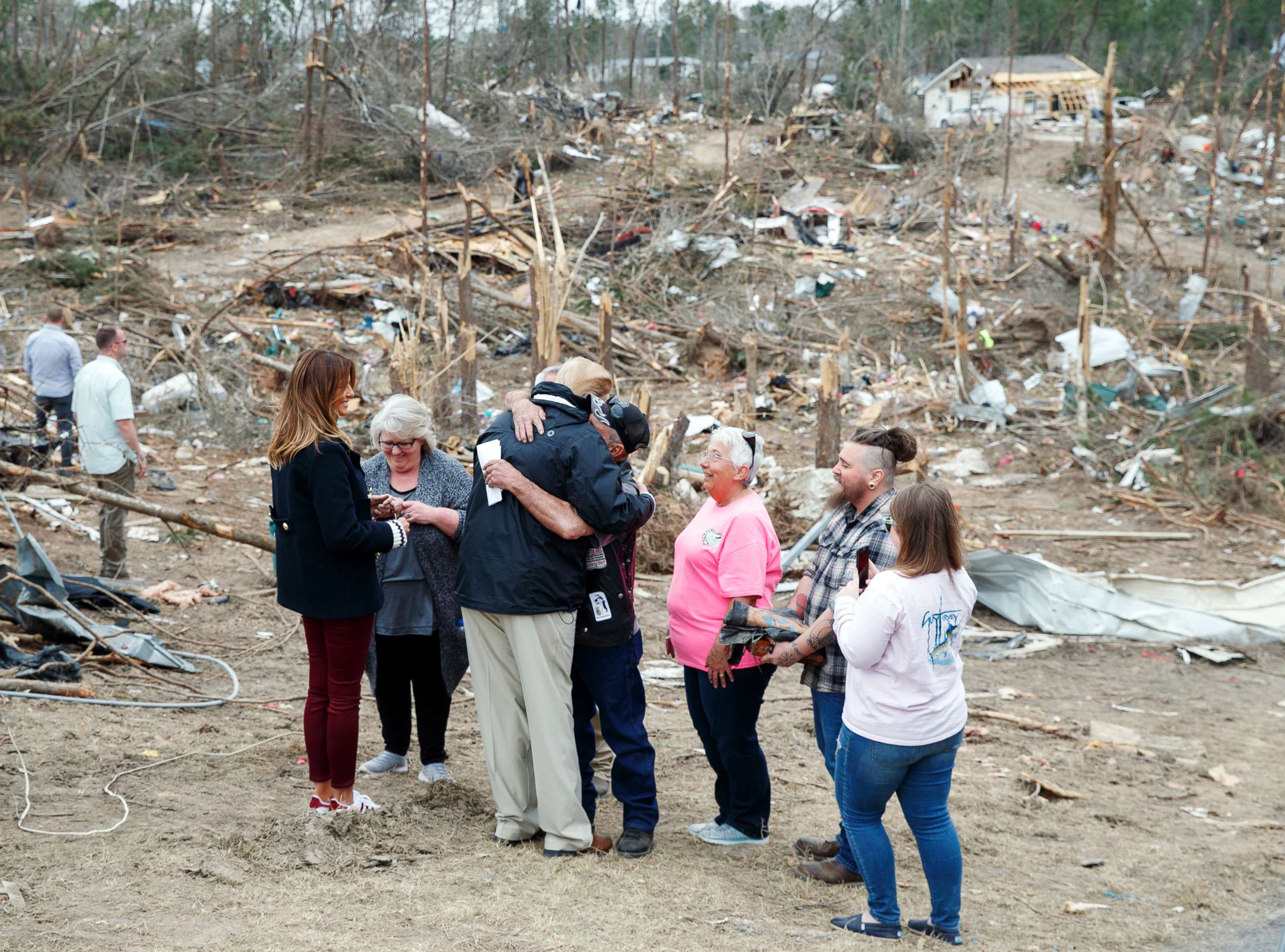 PHOTO: President Donald Trump hugs a resident as he and first lady Melania Trump talk with people in Beauregard, Ala., as they travel to tour areas where tornadoes killed 23 people in Lee County, Ala., March 8, 2019.