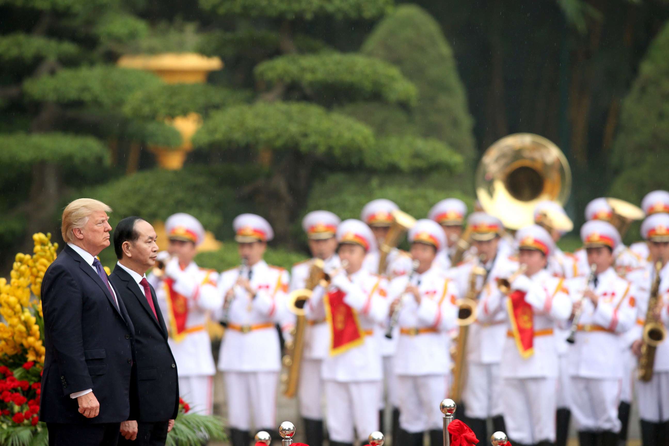 PHOTO: President Donald Trump, accompanied by Vietnamese President Tran Dai Quang, observe the playing of national anthems during a welcoming ceremony at the Presidential Palace in Hanoi, Nov. 12, 2017.