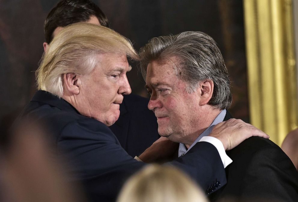 PHOTO: In Jan. 22, 2017, President Donald Trump congratulates Senior Counselor to the President Stephen Bannon during the swearing-in of senior staff in the East Room of the White House in Washington, DC.