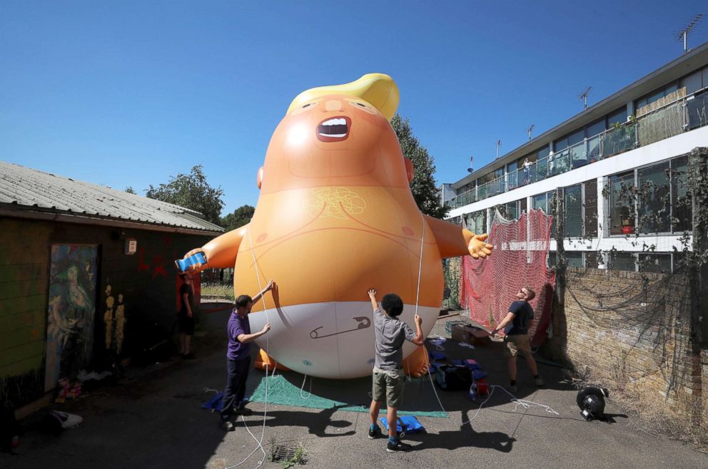 PHOTO: People inflate a helium filled Donald Trump blimp, which they hope to deploy during the President's upcoming visit, in London, June 26, 2018.