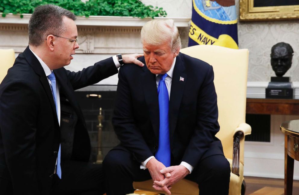 PHOTO: President Donald Trump prays with American pastor Andrew Brunson in the Oval Office of the White House, Oct. 13, 2018, in Washington.