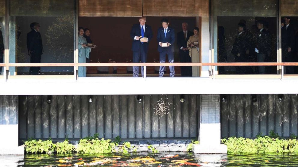 PHOTO: President Donald Trump and Japanese Prime Minister Shinzo Abe feed koi fish during a welcoming ceremony in Tokyo on Nov. 6, 2017.