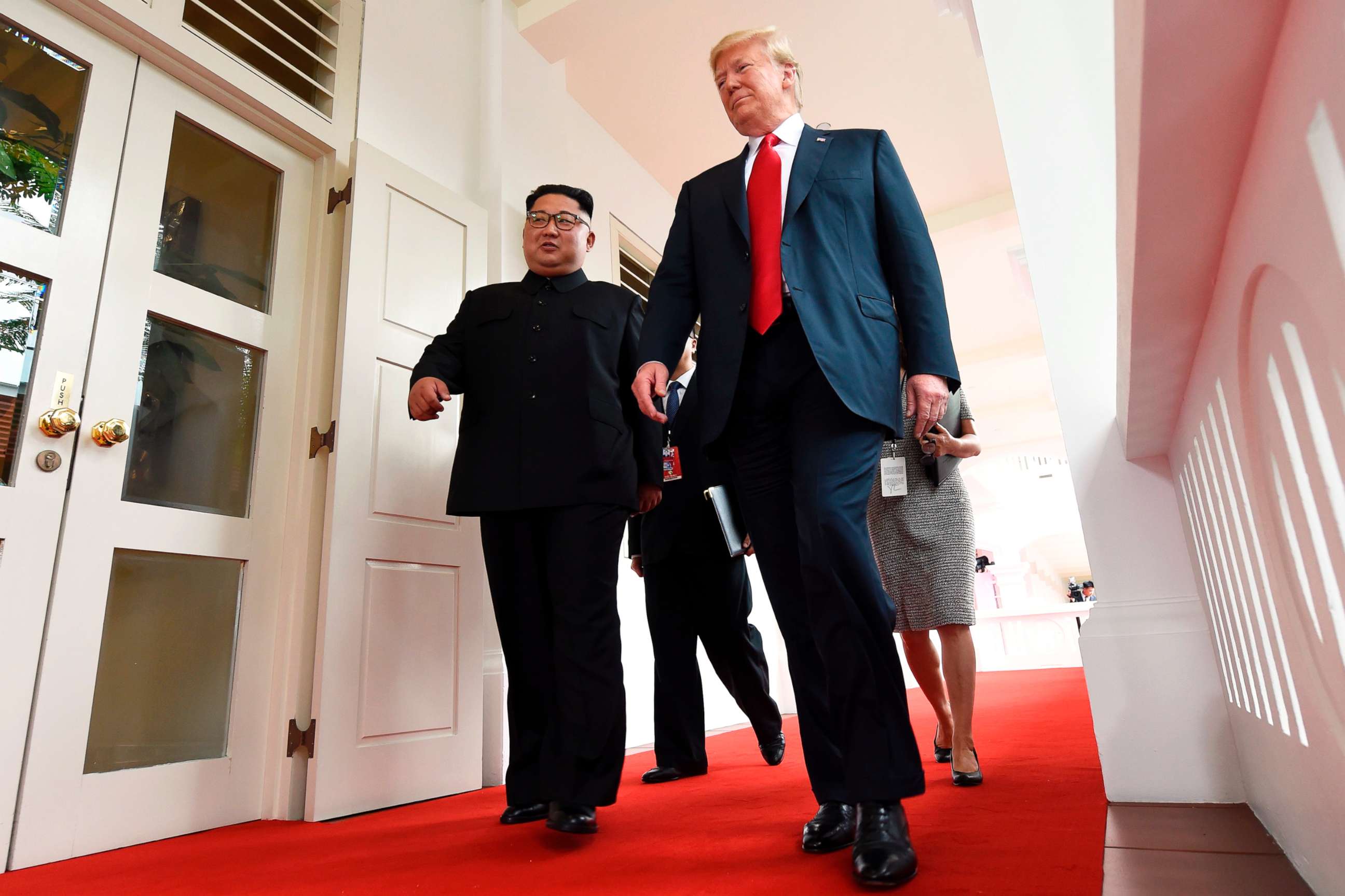 PHOTO: North Korea's leader Kim Jong Un walks with President Donald Trump at the start of their summit, at the Capella Hotel on Sentosa island, in Singapore, on June 12, 2018.