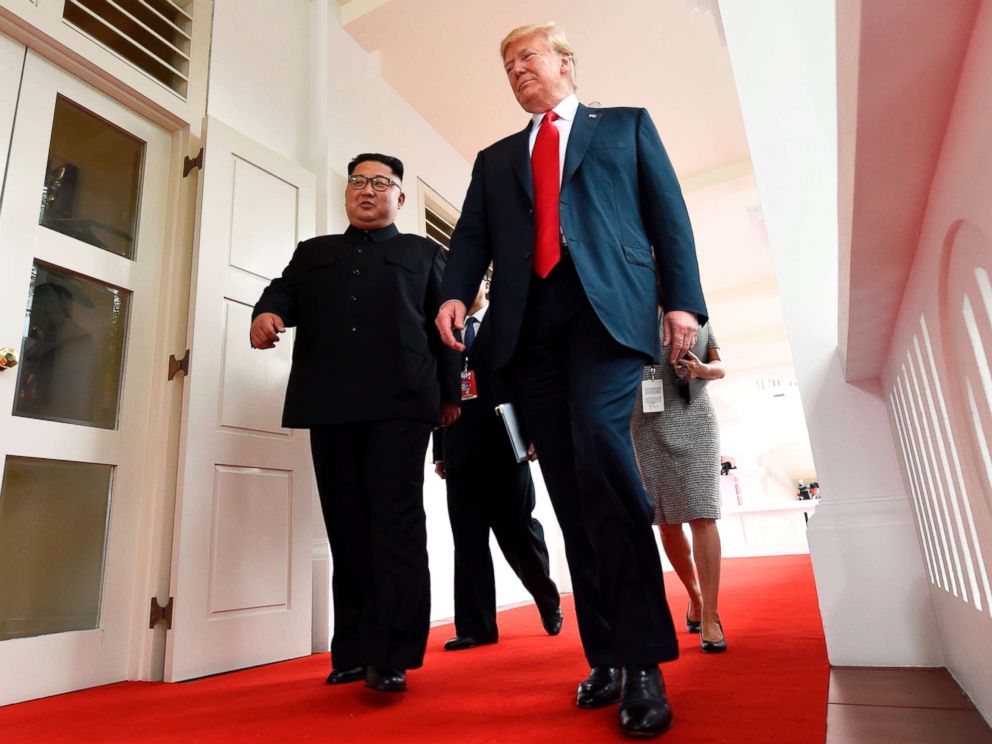 PHOTO: North Koreas leader Kim Jong Un walks with President Donald Trump at the start of their summit, at the Capella Hotel on Sentosa island, in Singapore, on June 12, 2018.