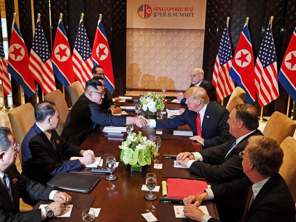 PHOTO: President Donald Trump shakes hands with North Koreas leader Kim Jong Un as they sit down with their respective delegations for the U.S.-North Korea summit, at the Capella Hotel on Sentosa island in Singapore on June 12, 2018.