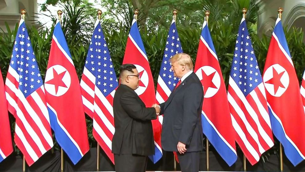 President Donald Trump and North Korean leader Kim Jong Un pose together ahead of their meeting at Capella Hotel in Singapore, on June 12, 2018.