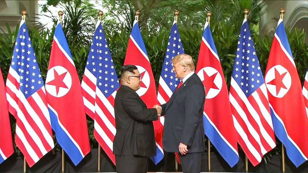 PHOTO: President Donald Trump and North Korean leader Kim Jong Un pose together ahead of their meeting at Capella Hotel in Singapore, on June 12, 2018.