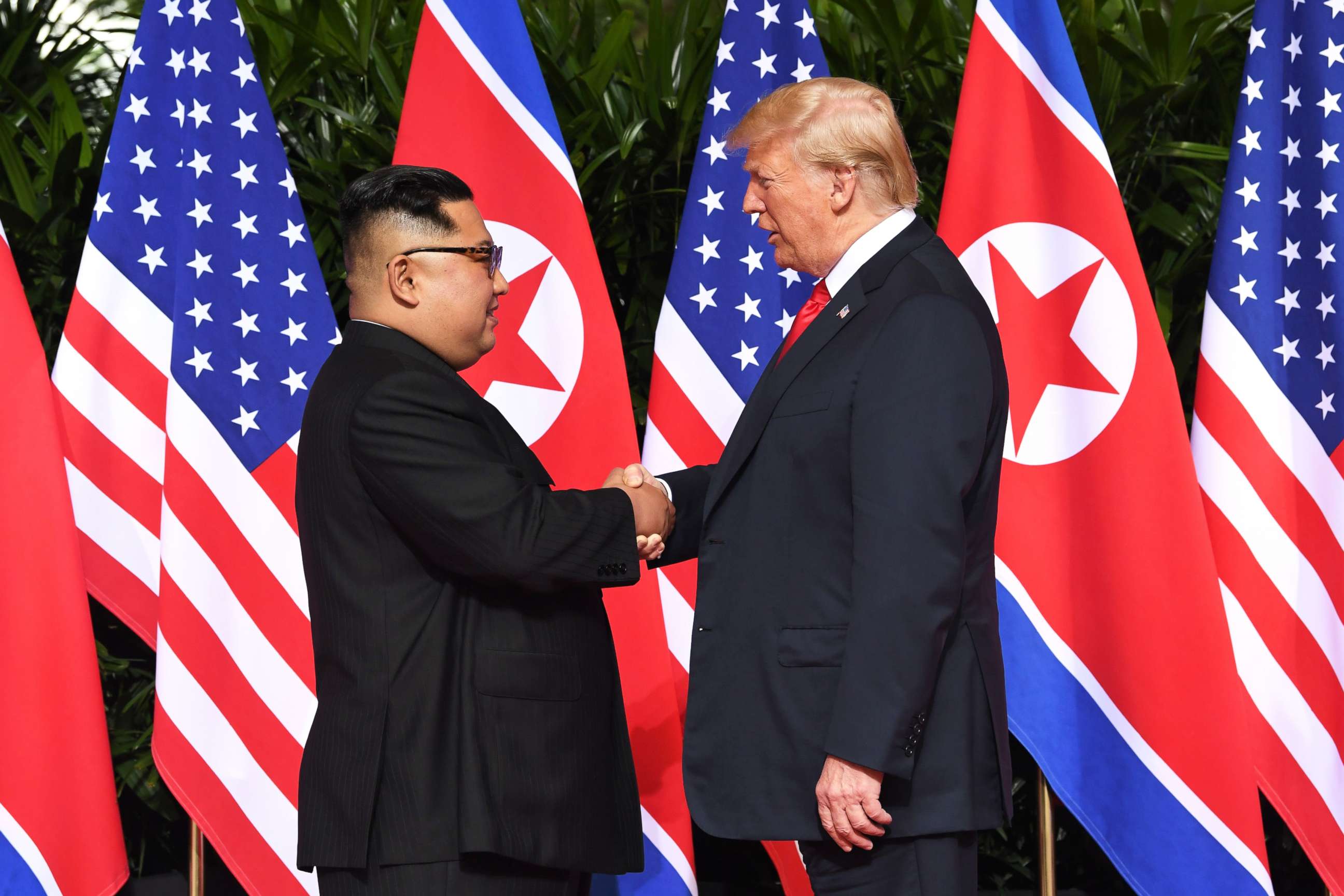 PHOTO: North Korea's leader Kim Jong Un shakes hands with President Donald Trump at the start of their historic summit, at the Capella Hotel on Sentosa island in Singapore on June 12, 2018.