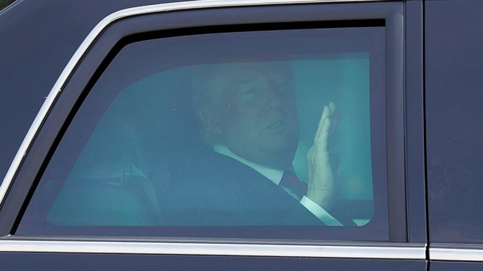 PHOTO: President Donald Trump waves from inside his car as he heads into the Istana Presidential Palace, where he will meet with Singapore Prime Minister Lee Hsien Loong, 11 June 2018.