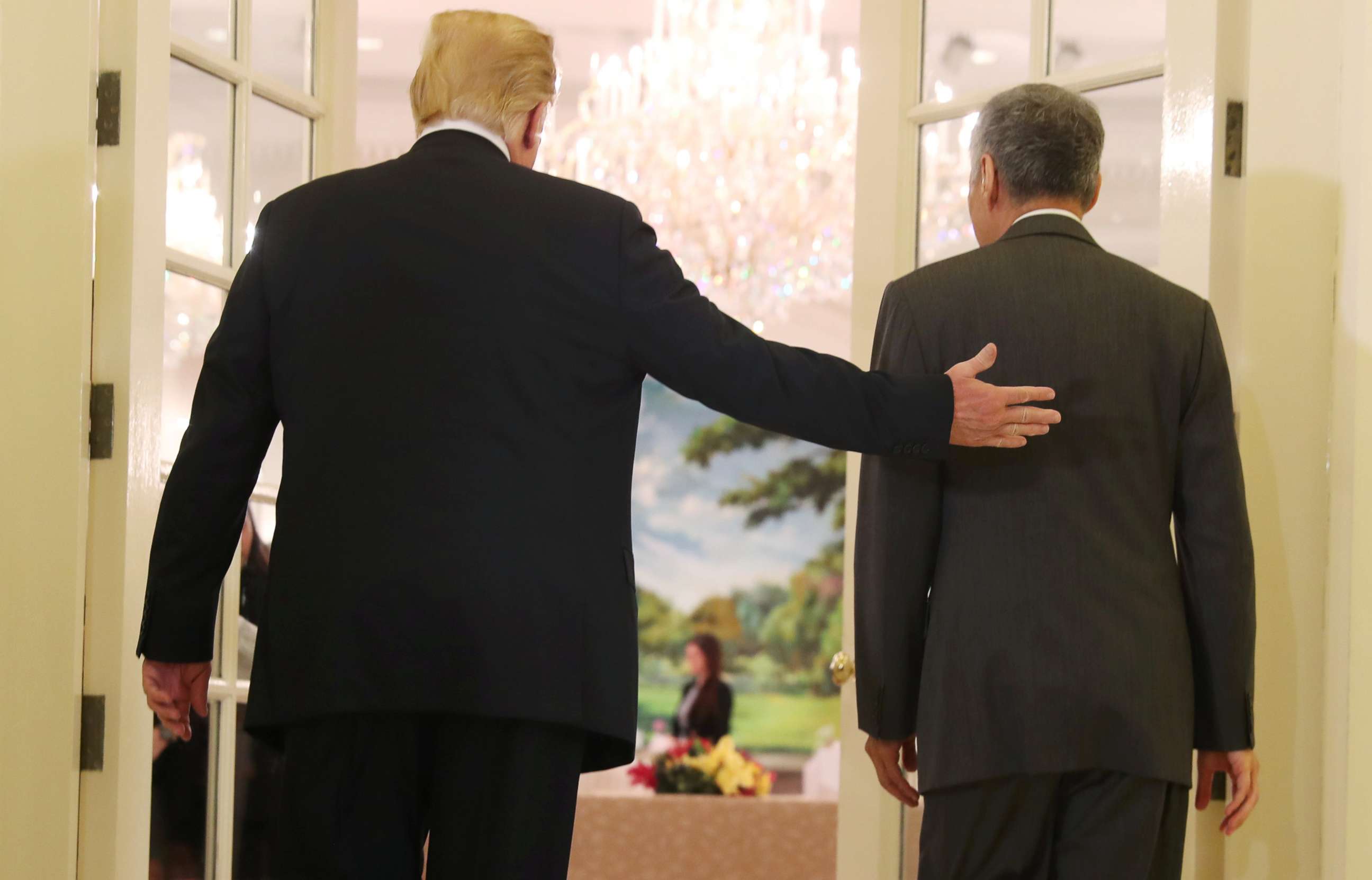 PHOTO: President Donald Trump and Singapore's Prime Minister Lee Hsien Loong walk together during a meeting at the Istana in Singapore June 11, 2018.