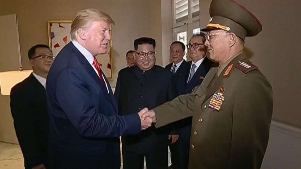 PHOTO: Video shown by North Korean state television shows President Donald Trump shaking hands with a North Korean general while North Korean leader Kim Jong Un looks on during a summit in Singapore, June 12, 2018.