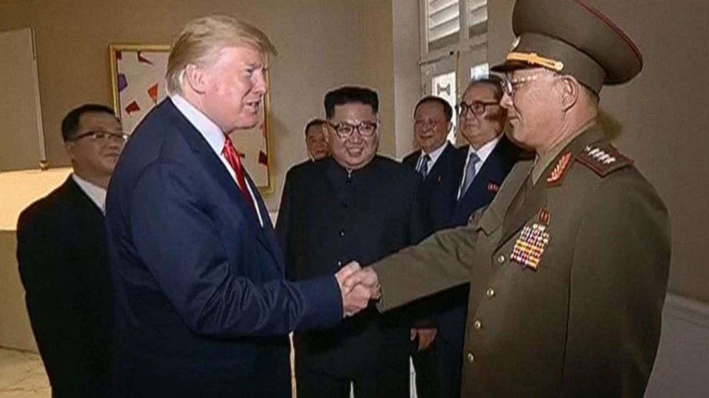 PHOTO: Video shown by North Korean state television shows President Donald Trump shaking hands with a North Korean general while North Korean leader Kim Jong Un looks on during a summit in Singapore, June 12, 2018.