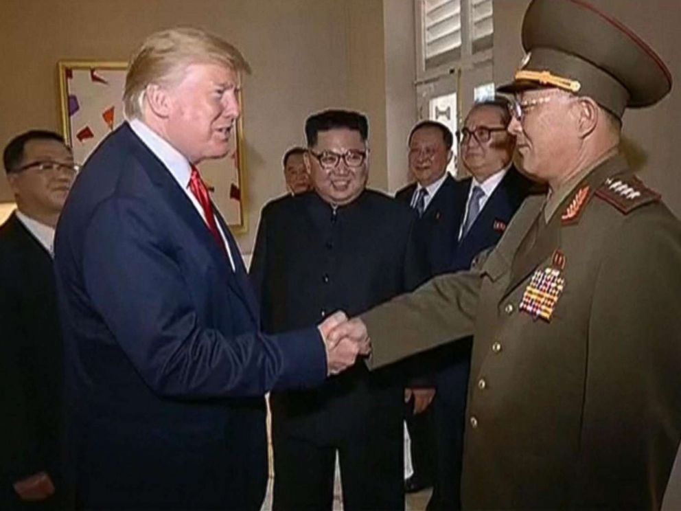 PHOTO: Video shown by North Korean state television shows President Donald Trump shaking hands with a North Korean general while North Korean leader Kim Jong Un looks on during a summit in Singapore, June 12, 2018.