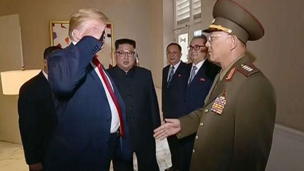 PHOTO: Video shown by North Korean state television shows President Donald Trump saluting a North Korean general while North Korean leader Kim Jong Un looks on during a summit in Singapore, June 12, 2018.