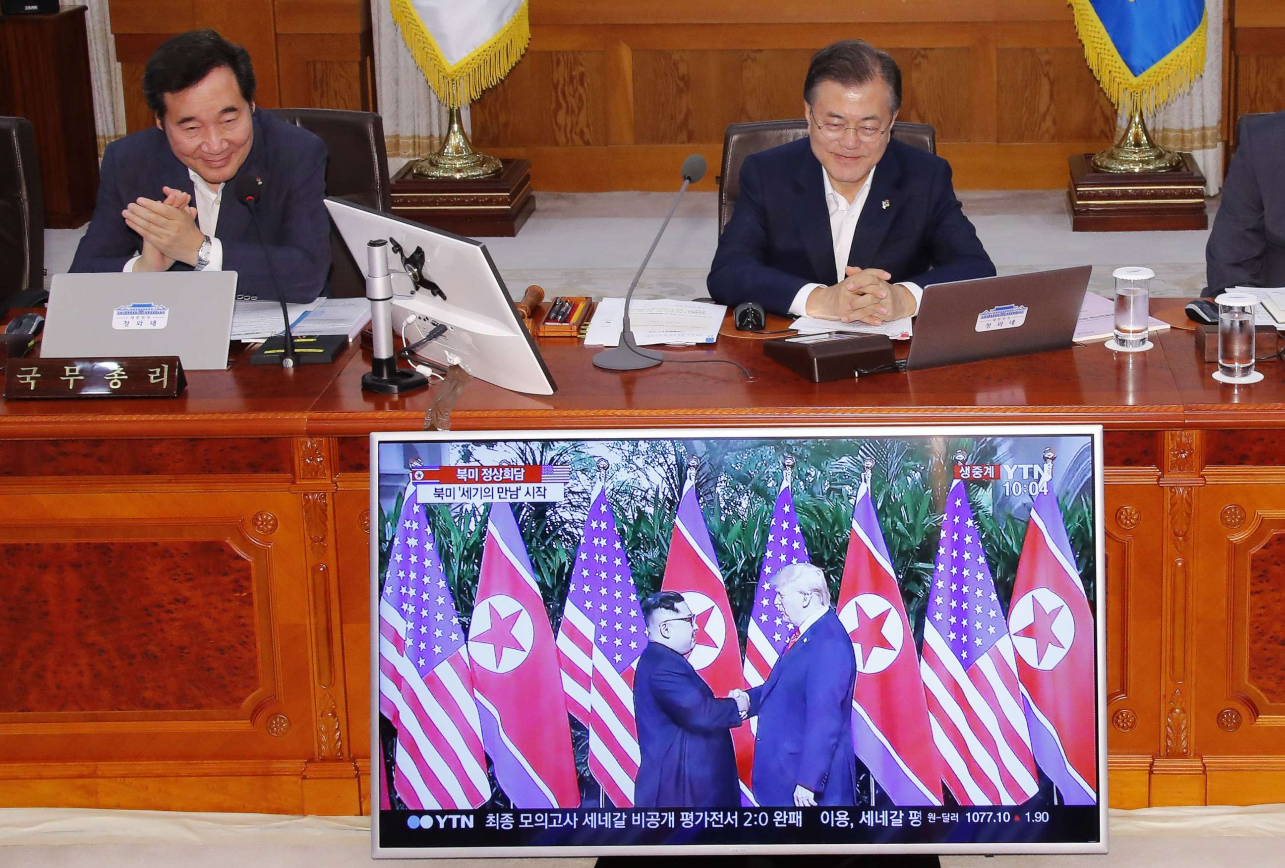 PHOTO: South Korean Prime Minister Lee Nak-yon and President Moon Jae-in watch a television screen showing the summit between President Donald Trump and North Korean leader Kim Jong Un during a Cabinet meeting in Seoul on June 12, 2018.