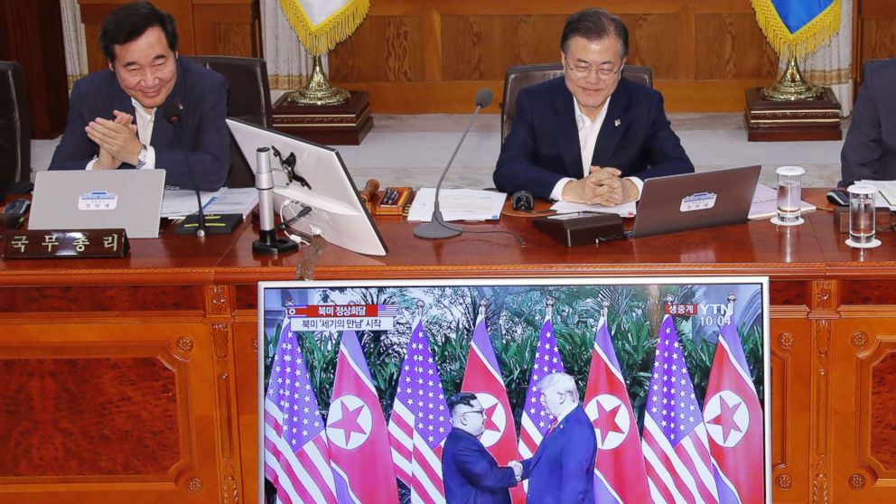 South Korean Prime Minister Lee Nak-yon and President Moon Jae-in watch a television screen showing the summit between President Donald Trump and North Korean leader Kim Jong Un during a Cabinet meeting at the presidential Blue House in Seoul on June 12, 2018.