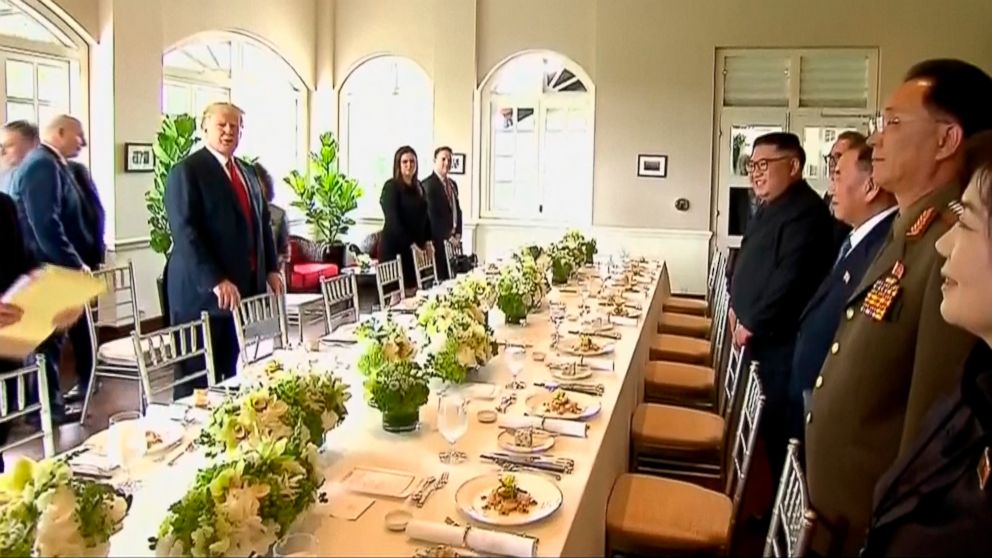 PHOTO: In this image made from video provided by Host Broadcaster Mediacorp Pte Ltd,, U.S. President Donald Trump and North Korean leader Kim Jong Un arrive for a working lunch at Capella Hotel in Singapore, June 12, 2018.