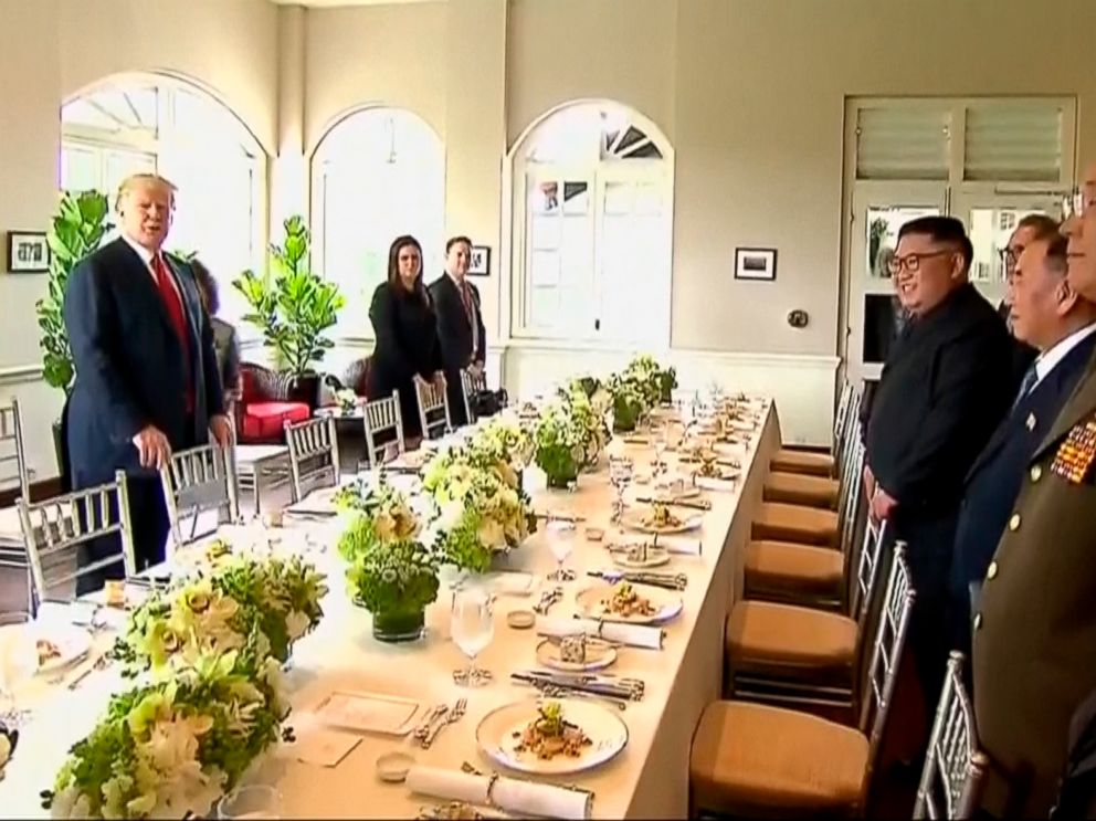 PHOTO: In this image made from video provided by Host Broadcaster Mediacorp Pte Ltd,, U.S. President Donald Trump and North Korean leader Kim Jong Un arrive for a working lunch at Capella Hotel in Singapore, June 12, 2018.
